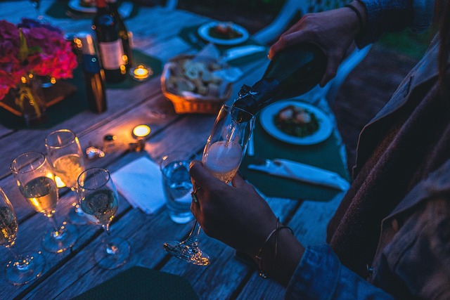 A hostess pouring drinks in a dimly lit club